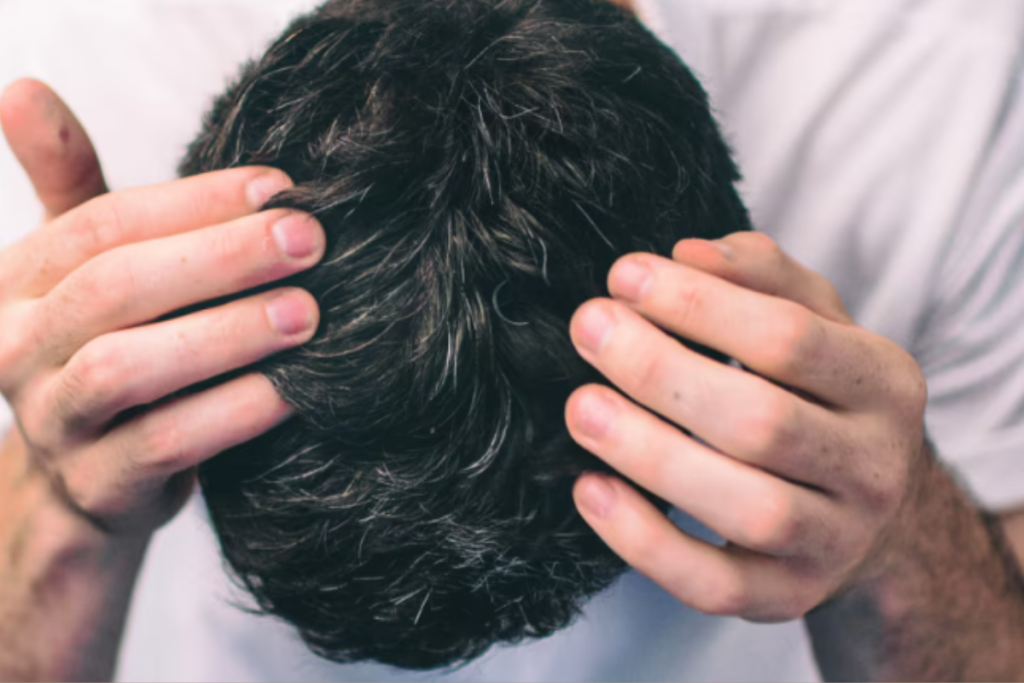 Close-up of a man’s face or hands with hair dye stains, holding a cotton pad with cleanser — natural, realistic look, showing the “problem.”