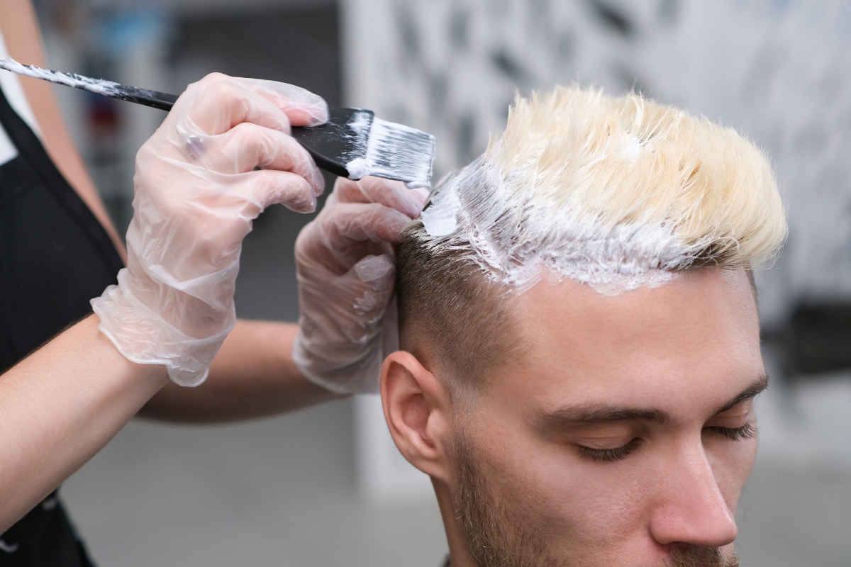 barber bleaching hair man