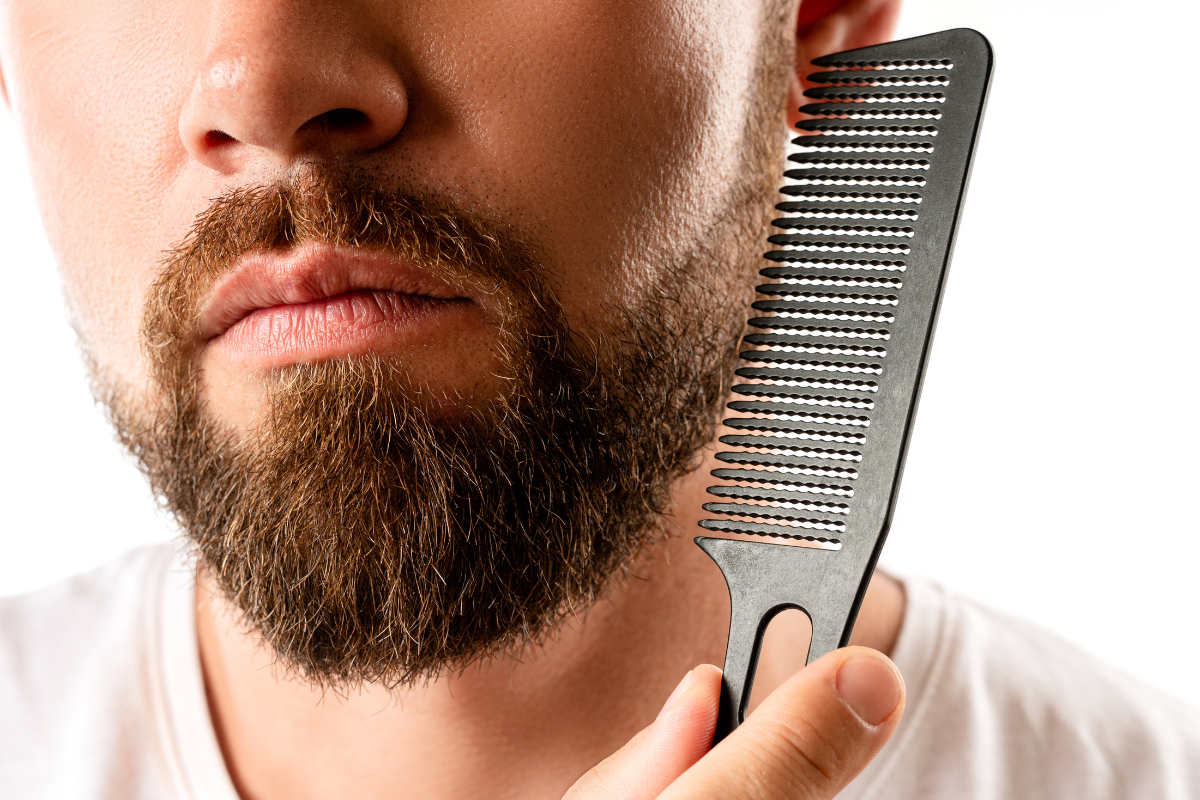 man combing beard