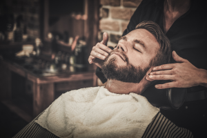 man grooming sideburns mirror modern barber shop