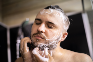 clean beard being washed with foamy shampoo