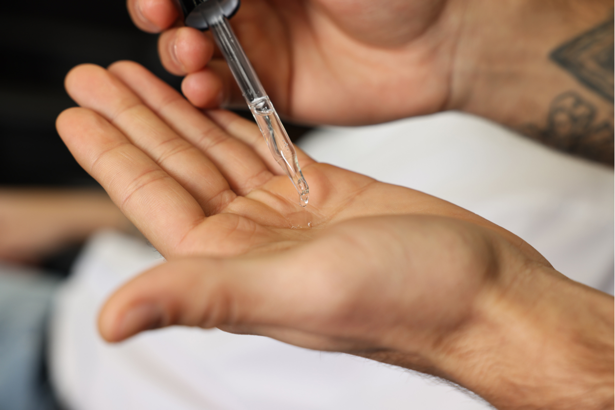 man applying beard oil