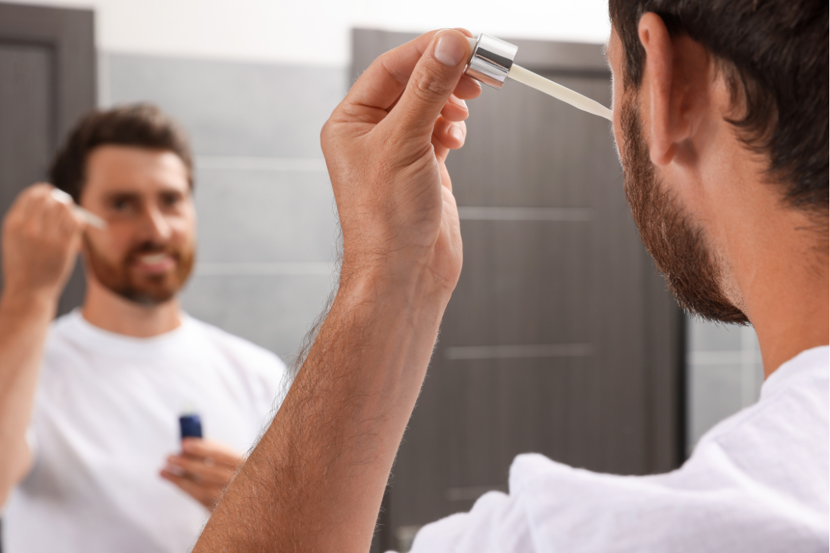 man applying beard oil