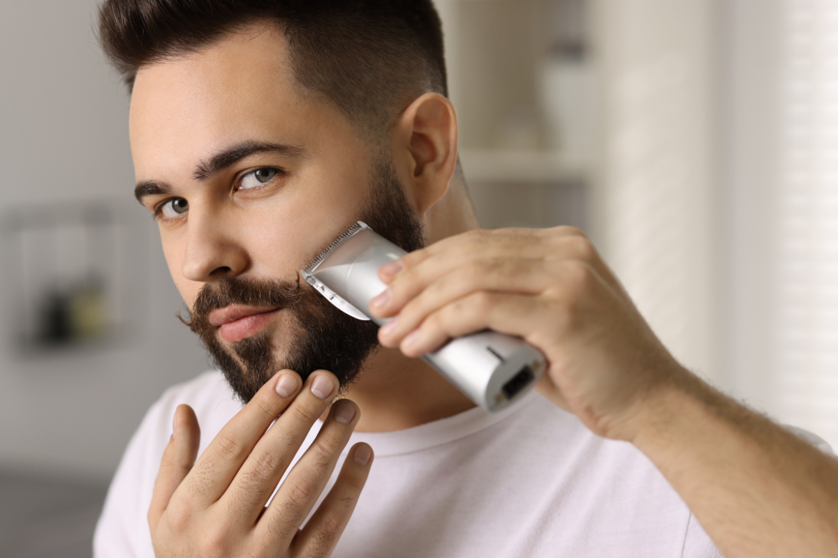 man grooming beard at home
